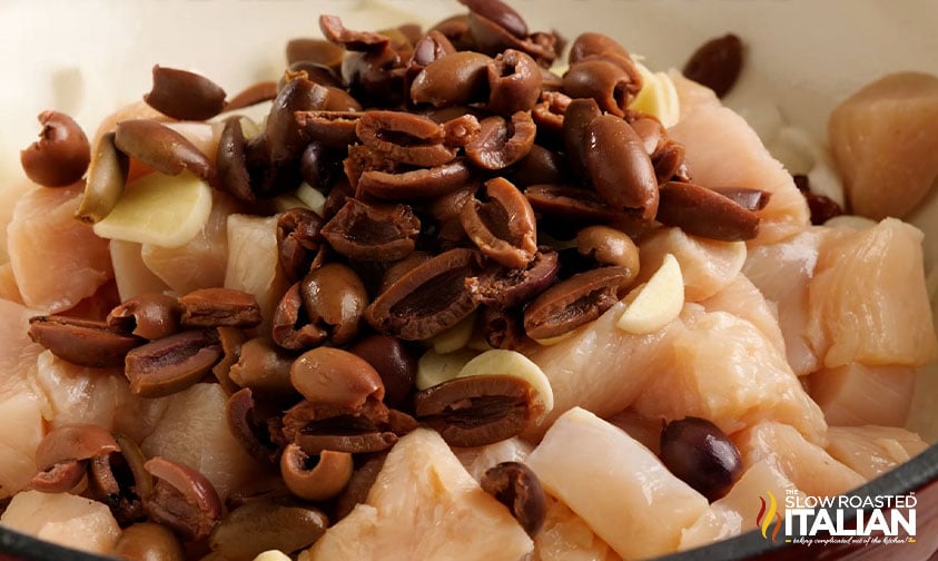 cut chicken breasts with kalamata olives